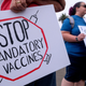 Anti-vaccination protesters holding signs take part in a rally against covid-19 vaccine mandates, in Santa Monica, California, on August 29, 2021.